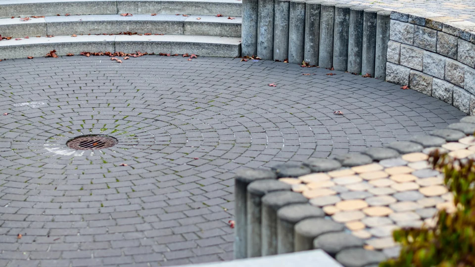 Completed paver plaza with steps, seat wall, and landscaping