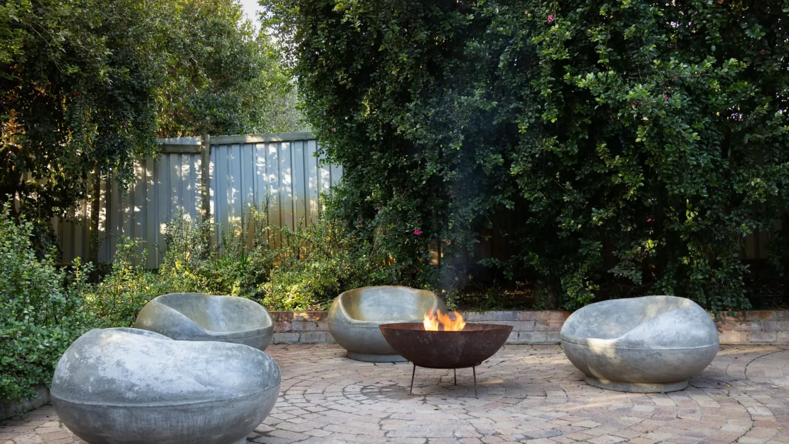 Custom paver patio with an outdoor living space and fire pit